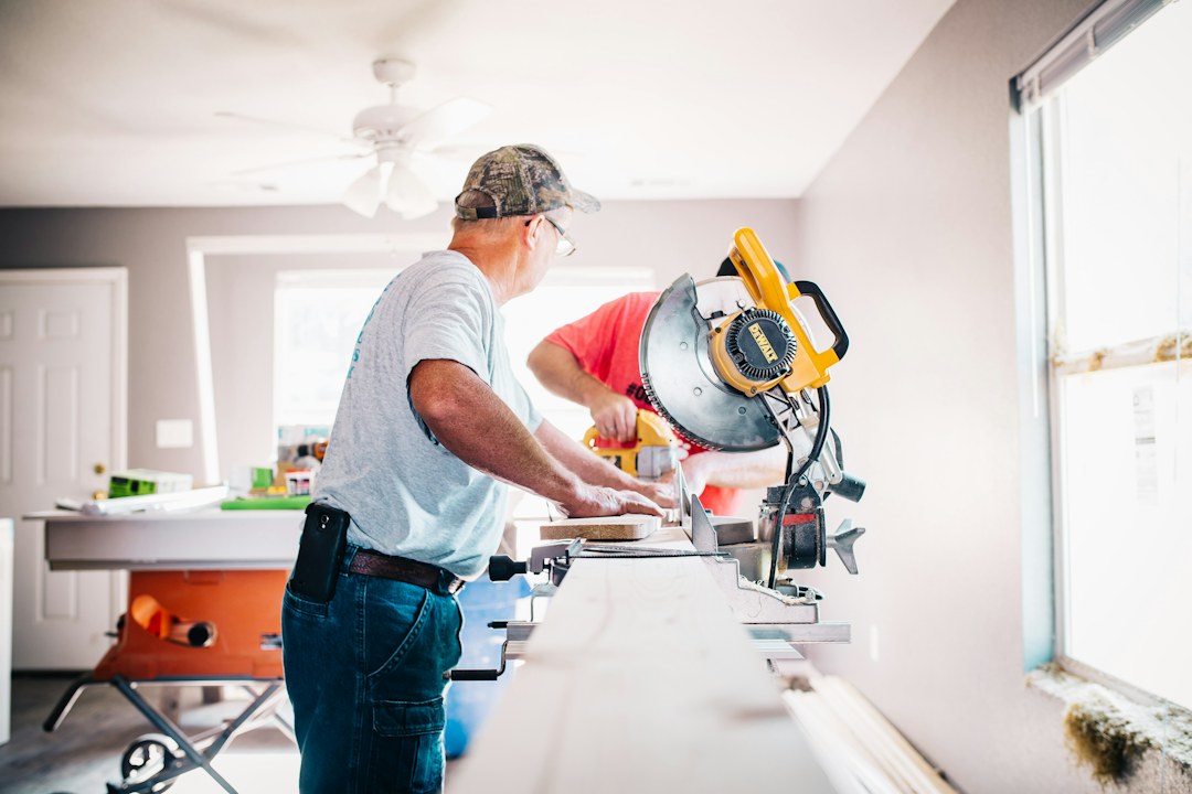 Contractor performing home repair work with professional tools